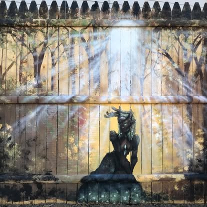 Forest mural painted on a garden fence