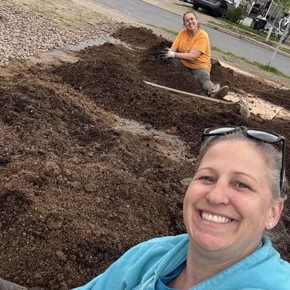 Volunteers preparing soil for the garden